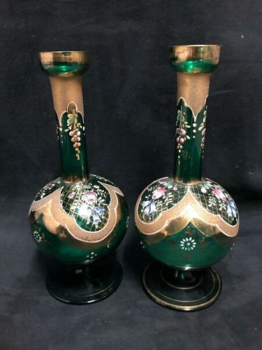 A pair of small green glass vases painted with enamel