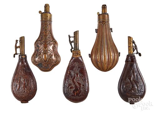 Five copper and leather powder flasks, 19th c.
