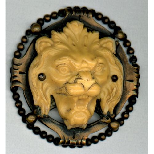 A HIGH RELIEF DIVISION 1 IVOROID LION HEAD IN METAL