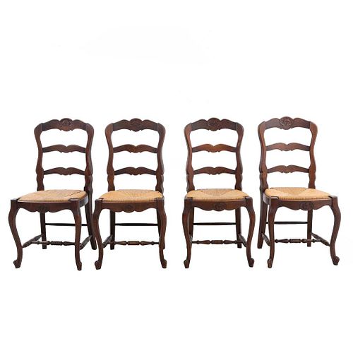 Lote de 4 sillas. Francia. Siglo XX. Estilo Luis XV. En talla de madera de roble. Con respaldos escalonados y asientos de palma.