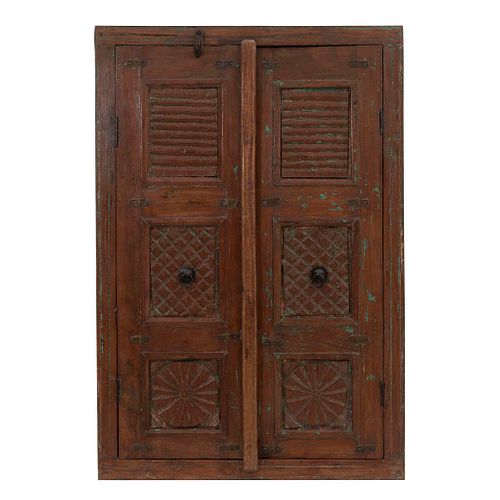 Cabinet. 20th century. Carved in wood. Two hinged doors with handles. Decorated with geometric elements. 40.5 x 27.5 x 6.6" (103 x 70 x 17 cm)