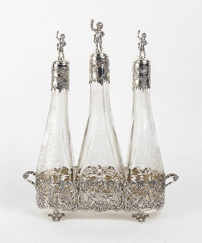 An Italian silver 800/1000 and cut glass three bottle decanter - early 20th Century, Basios
