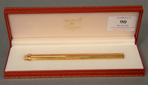 Cartier Les Must gold plated ballpoint pen in original box.
