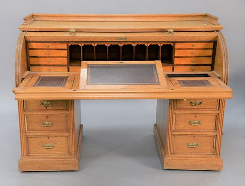 Large oak roll-top desk with fitted interior and leather pull-out writing area, ht. 48", wd. 66", dp. 31".