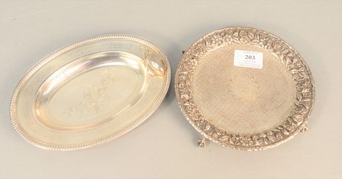 Two sterling nut dishes to include oval with bird and molded nut and a round Kirk & Son repousse with flowers on ball and claw feet, 13.9 t.oz.