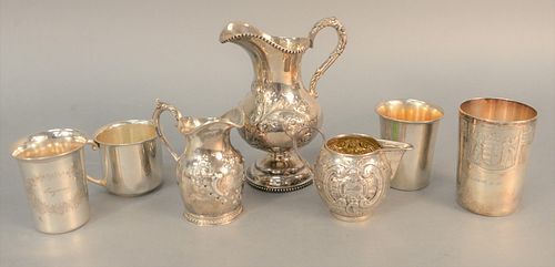 Silver lot to include three-piece repousse tea set along with four cups, pitcher ht. 7", Estate of Tom & Alice Kugelman.