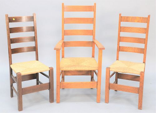 Set of twelve mission oak dining chairs with woven seats.