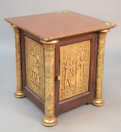 Egyptian-style low cabinet having one door with embossed panels, ht. 26", top 24" x 24". Estate of Thomas Izard.