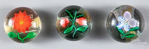 Three glass floral paperweights