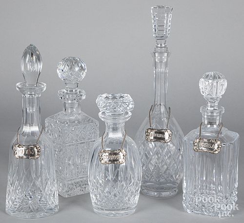 Five colorless glass decanters