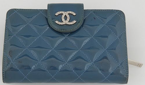Chanel Blue Patent Leather Wallet, with silver tone button snap opening a blue leather interior with ten card holders and four bill...