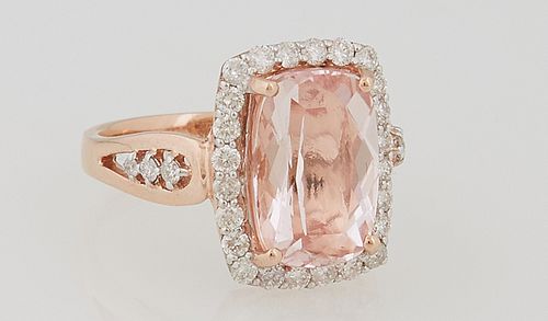 Lady's 14k Rose Gold Dinner Ring, with a cushion cut 4.76 carat morganite, atop a conforming border of round diamonds, the split should