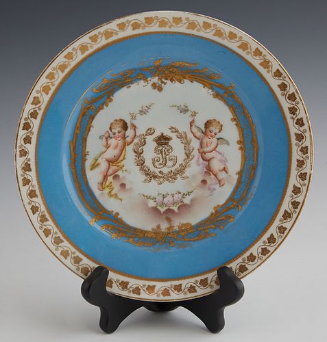 French Sevres Style Cabinet Plate, 19th c., with gilt and putti decoration, around an "LP" monogram, with a gilt leaf border around a heavenly blue ba