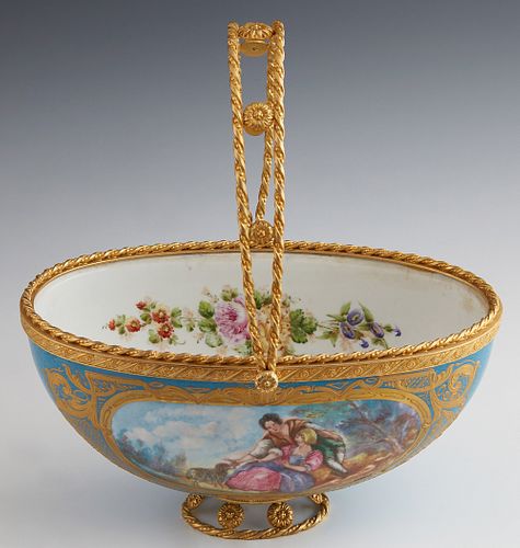 Sevres Gilt Bronze Mounted Porcelain Basket, 19th c., in Celestial Blue, one side with a reserve of lovers in a garden, signed Aurele, the interior wi