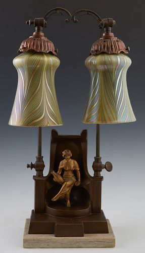 German Art Nouveau Patinated Spelter Table Lamp, c. 1910, with a seated female figure on a chair flanked by two columns, rising and bending over to tw