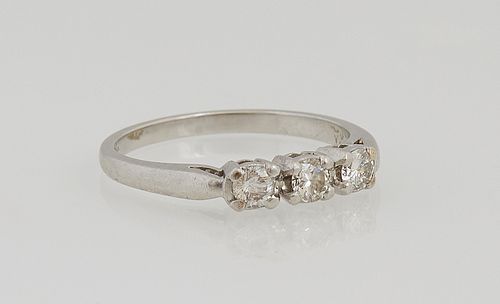 Lady's Platinum Dinner Ring, the top with a row of three 10 point round diamond, total diamond wt.-.3 cts, Size 5 3/4.
