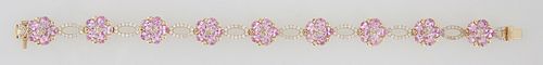 14K Yellow Gold Link Bracelet, each of the 9 floriform links with a central round diamond flanked by 5 oval pink sapphire "petals," joined by 9 pierce
