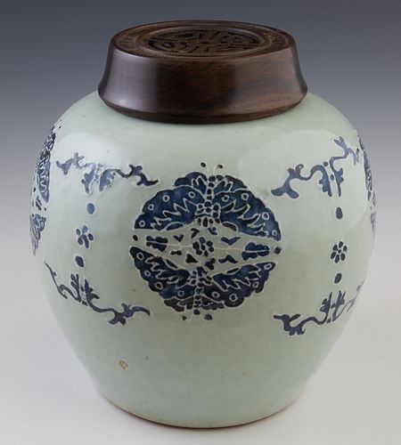 Chinese Celadon Porcelain Quanlong Baluster Ginger Jar, 18th c., with relief blue decoration, now with an openwork carved mahogany lid, the bottom wit