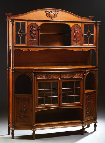 Unusual English Carved Mahogany Art Nouveau Sideboard, c. 1910, the arched relief crest over a breakfront upper section, with a central open shelf fla