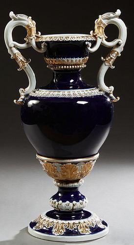 Large Meissen Cobalt Handled Urn, 19th c., of tapering form, with elaborate scrolled handles and gilt relief highlights, on a socle support to a circu
