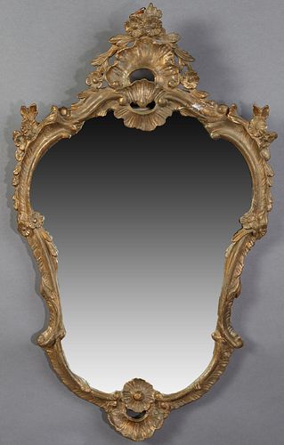 French Gilt and Gesso Overmantel Mirror, late 19th c., the arched pierced floral carved crest over a shaped scrolled leaf and floral relief frame, the
