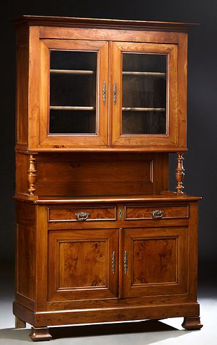 French Louis Philippe Carved Elm Buffet a Deux Corps, 19th c., the stepped crown over double glazed doors on turned tapered supports, to a rounded cor
