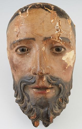 Italian Polychromed Carved Wood Santo Head, 19th c., in original paint, H.- 10 in., W.-5 in., D.- 4 in. Provenance: Personal collection of Paul Rosent