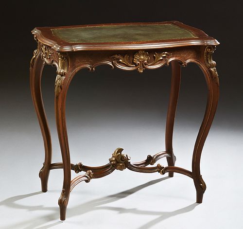 French Louis XV Style Carved Oak Side Table, early 20th c., the stepped tortoise top with an inset gilt tooled leather insert, on cabriole legs joined