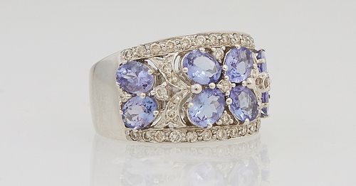 Lady's 14K White Gold Dinner Ring, the tapering wide top with 8 oval .2 ct. tanzanites, separated by small round diamonds, within an edge border of sm