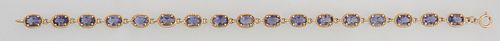 14K Yellow Gold Link Bracelet, each of the 17 oval links with an oval app. .89 carat tanzanite, within a rope twist 14K gold border, Total tanzanite w