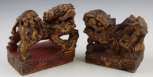 Pair of Chinese Carved Polychromed Marble Foo Dogs, late 19th c., in red paint with gilt highlights, H.- 6 in., W.- 6 in., D.- 3 3/4 in.