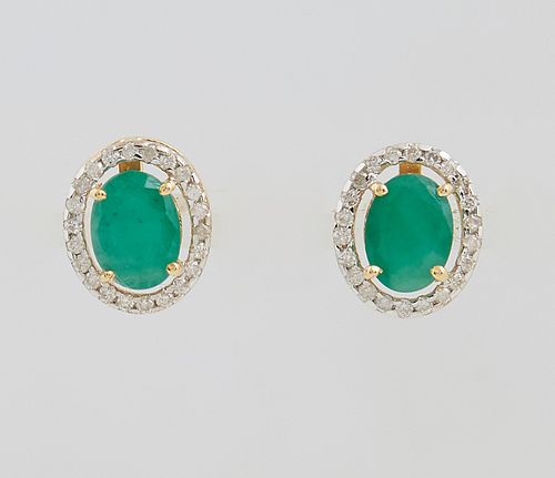 Pair of 14K Yellow Gold Stud Earrings, each with a 1.34 ct. oval emerald atop a border of smll round dimonds, total emerald wt.- 2.68 cts., total diam
