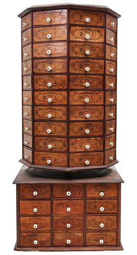 A MONUMENTAL TWO-TIER REVOLVING NUT AND BOLT CABINET
