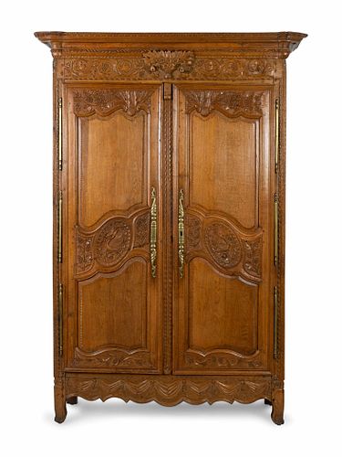 A Louis XV Provincial Style Carved Walnut Armoire
Height 85 x width 53 1/2 x depth 22 inches.