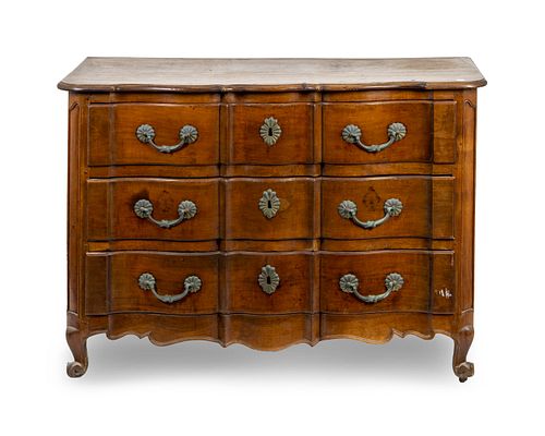 A Louis XV Provincial Style Serpentine-Fronted Walnut Commode
Height 36 x width 50 3/4 x depth 24 1/4 inches.