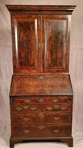 A rare George II oyster walnut secretary bookcase 1750