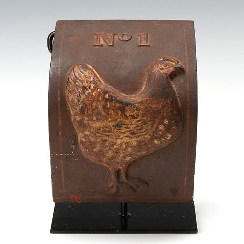 AN ANTIQUE CAST IRON COVER WITH HEN IN OLD PAINT