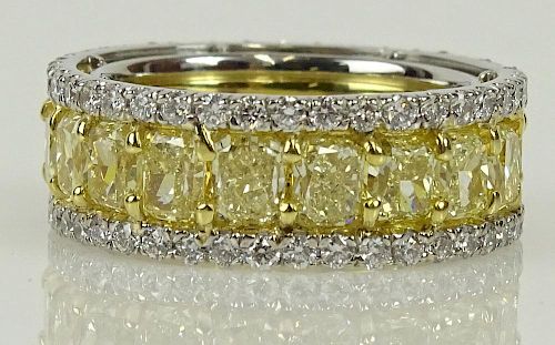EGL certified 8.23 carat rectangular cut fancy intense yellow diamond and platinum eternity band.