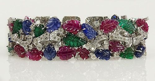 Cartier style approx. 82.0 carat carved sapphire, ruby  emerald, and diamond 18 karat gold tutti-frutti bracelet.