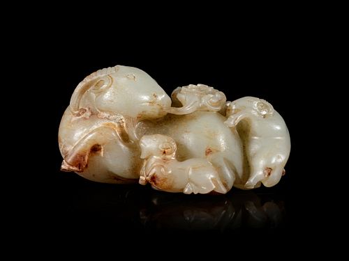 A Carved Celadon and Russet Jade 'Three Rams' Group
Length 3/12 in., 8.3 cm.