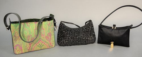 Three clutch purses or handbags to include Gucci black satin clutch purse with original tag $525 and dust cover; Dolce & Gabbana paisley purse with ce
