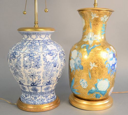 Two contemporary table lamps to include gilt decorated and reverse printed glass lamp with blue floral decoration, ht. 17" along with blue and white p