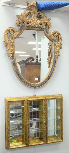 Three piece group to include shield form framed mirror, 40" x 29"; hanging curio cabinet and a contemporary mirror, 24" x 31".