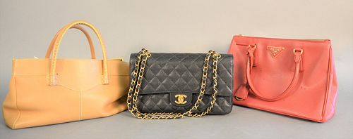 Group of four purses and wallets including: Prada red handbag and red wallet; Tod's tan handbag; and a black handbag marked Chanel (may not be authent