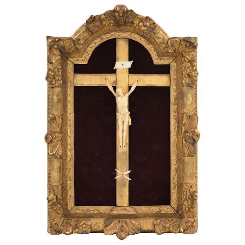 Ivory Christ, Early 20th century, Made in ivory with a carved wooden cross on a red velvet background.
