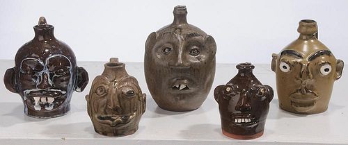 Five Small Pottery Face Jugs