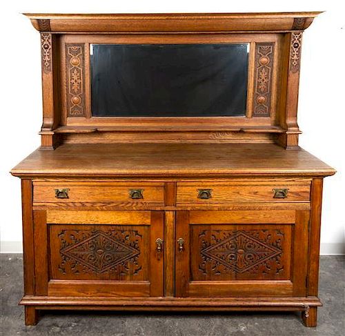 * An English Arts and Crafts Oak Sideboard, Robson and Sons, Ltd., Newcastle Height 74 1/4 x width 71 1/2 x depth 24 3/4 inches.