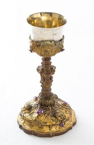 A Continental Brass and Silver-plate Sacramental Cup, , worked with relief cherub masks and set with 12 gemstones throughout