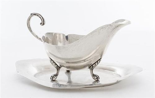 An American Silver Sauce Boat and Underplate, Mueck-Carey Co., New York, NY, raised on paw feet