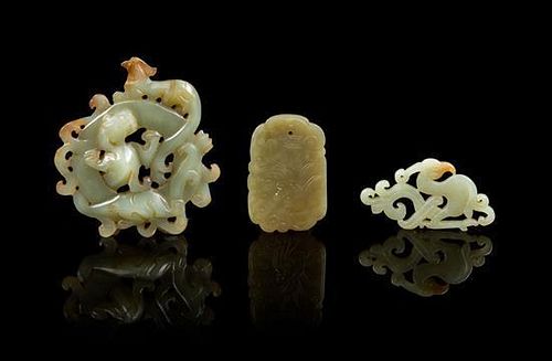 * A Group of Three Carved Jade Pendants Height of first 3 inches.